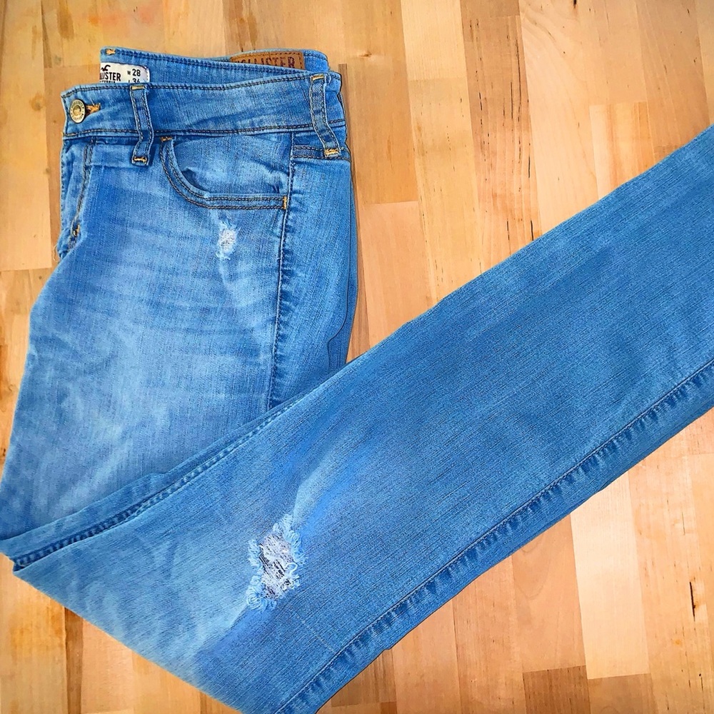 light colored jeans with small distressed holes made by designer